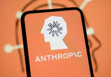 The Anthropic logo is displayed on the screen of a smartphone with the company's branding in the background.
