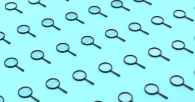 Repeated Magnifying Glass On Blue Background