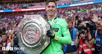 Crystal Palace keeper Dean Henderson holds up the Community Shield after his side's penalty shootout win over Liverpool