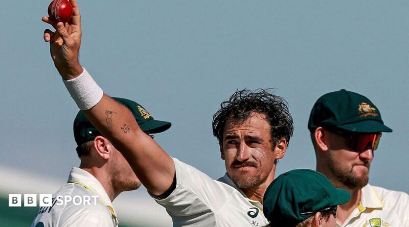 Australia cricketer Mitchell Starc celebrates his 10th wicket in the match by holding the ball up