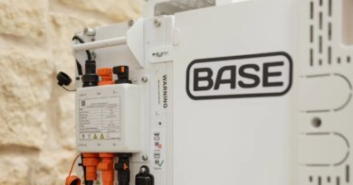 A Base Power battery sits next to a home.