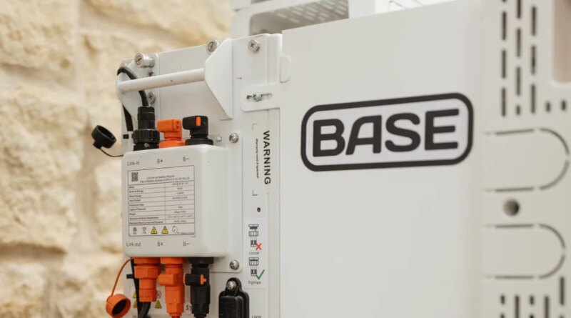A Base Power battery sits next to a home.