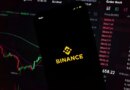 In this photo illustration, an iPhone displays the app and logo of popular cryptocurrency exchange platform Binance, with the desktop version in the background displaying market trends and exchange rates for cryptocurrency Bitcoin on 8th March, 2022 in Leeds, United Kingdom. (photo by Daniel Harvey Gonzalez/In Pictures via Getty Images)
