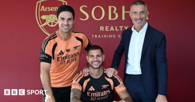 New Arsenal signing Bruno Guimaraes poses for a photograph with manager Mikel Arteta and sporting director Andrea Berta