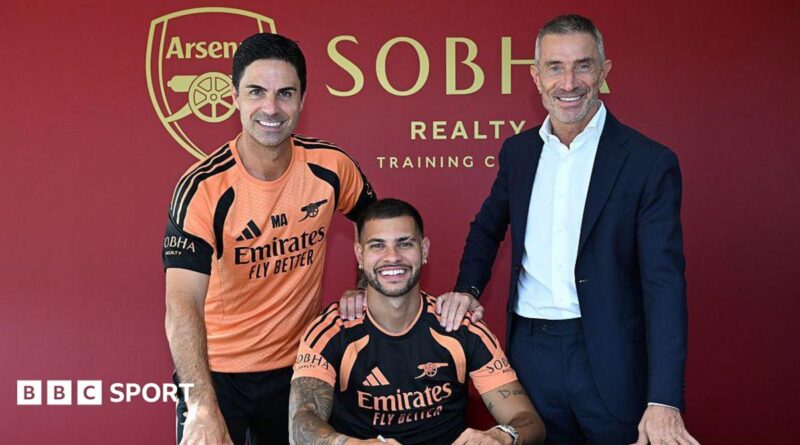New Arsenal signing Bruno Guimaraes poses for a photograph with manager Mikel Arteta and sporting director Andrea Berta