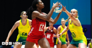 England's Liv Tchine tries to shield the ball from Australia in their bronze-medal match at the Commonwealth Games