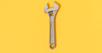 Adjustable wrench on yellow background