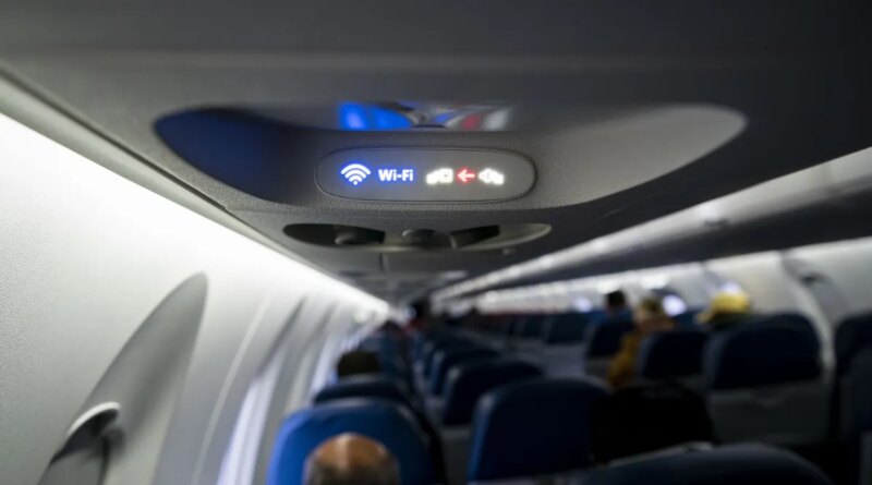 A Wi-Fi and fasten seat belts sign illuminated on a Delta Air Lines plane.