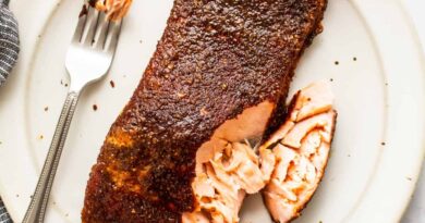 smoked salmon with fork on plate.