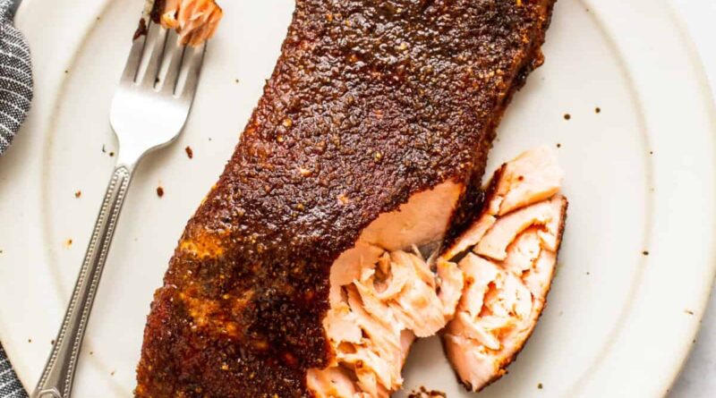 smoked salmon with fork on plate.