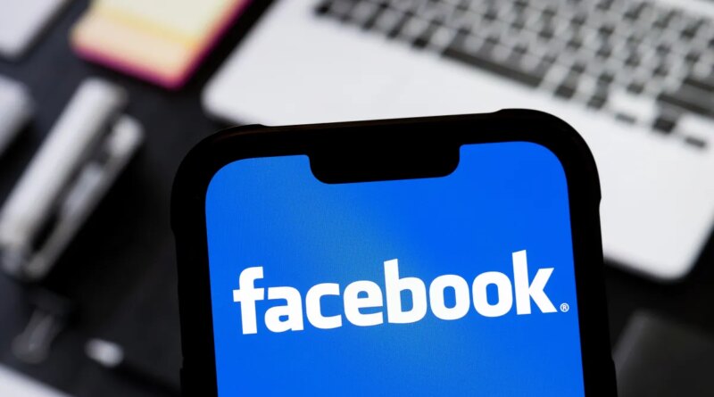 photo illustration of Facebook logo is seen displayed on a smartphone.