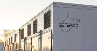 A grid-scale battery stands against a clear sky.