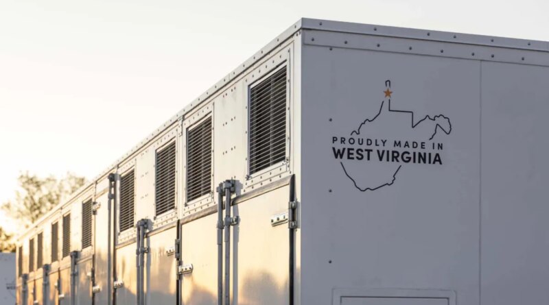 A grid-scale battery stands against a clear sky.