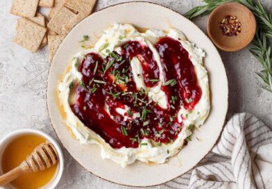 goat cheese dip topped with raspberry jam, fresh rosemary, and red pepper flakes served with crackers and hot honey