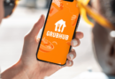 Grubhub app/logo displayed on a smartphone phone held in hand