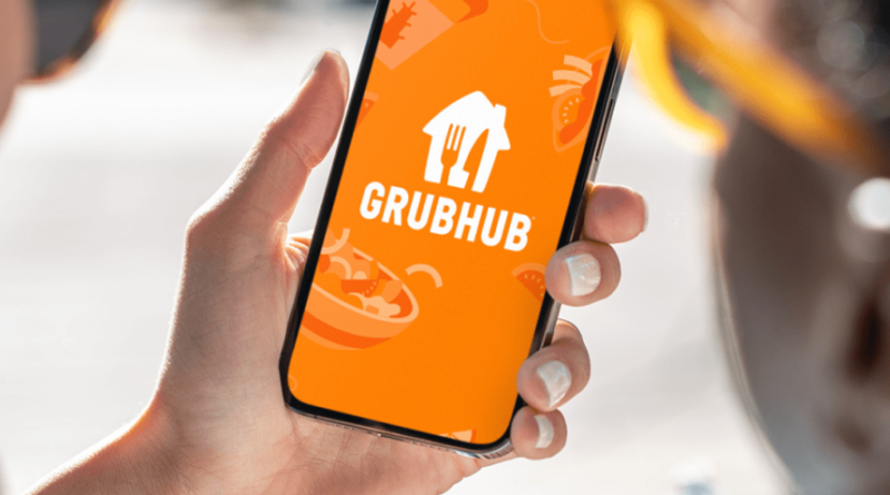 Grubhub app/logo displayed on a smartphone phone held in hand