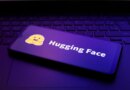 The Hugging Face logo appears on the screen of a smartphone.