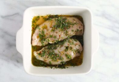 chicken marinating in dish.