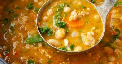 Sausage, bean and kale soup in a saucepan.