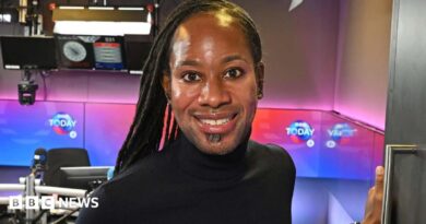 Jason Arday smiling in the doorway of a BBC radio studio in December 2023