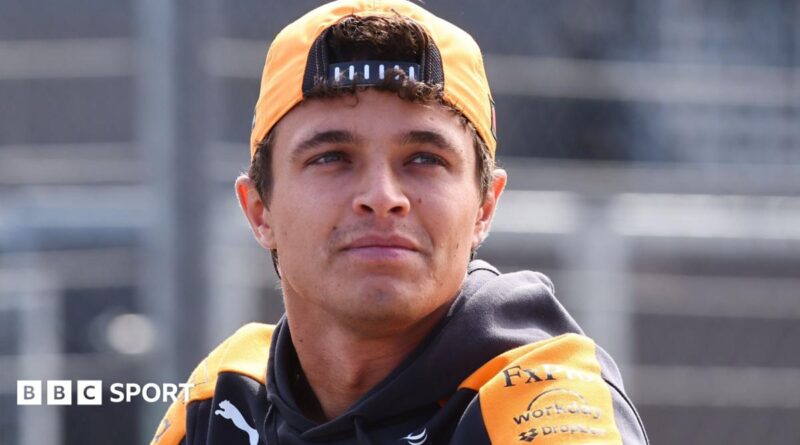 Lando Norris, in McLaren kit, pictured wearing a cap turned around backwards before the 2026 Dutch Grand Prix