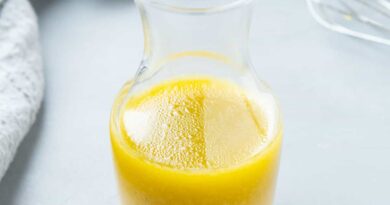 A small glass carafe filled with Maple Dijon Dressing.