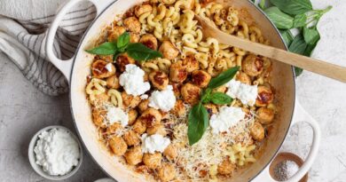 Skillet of mini cottage cheese meatballs and pasta with Parmesan, cottage cheese, and basil.