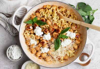 Skillet of mini cottage cheese meatballs and pasta with Parmesan, cottage cheese, and basil.