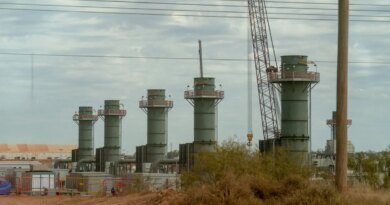 Five smoke stacks stand at a construction site in Texas.