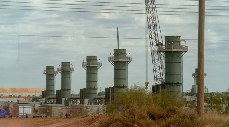 Five smoke stacks stand at a construction site in Texas.