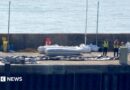A Border Force boat with a dinghy. 