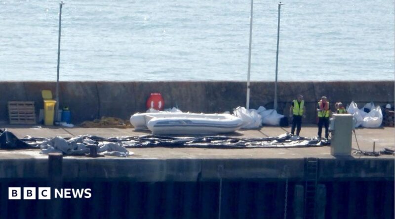 A Border Force boat with a dinghy.