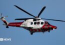A coastguard helicopter in red and white livery