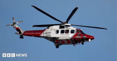 A coastguard helicopter in red and white livery