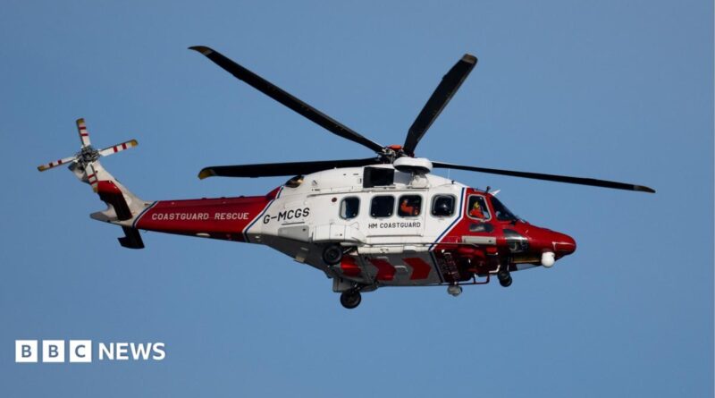 A coastguard helicopter in red and white livery