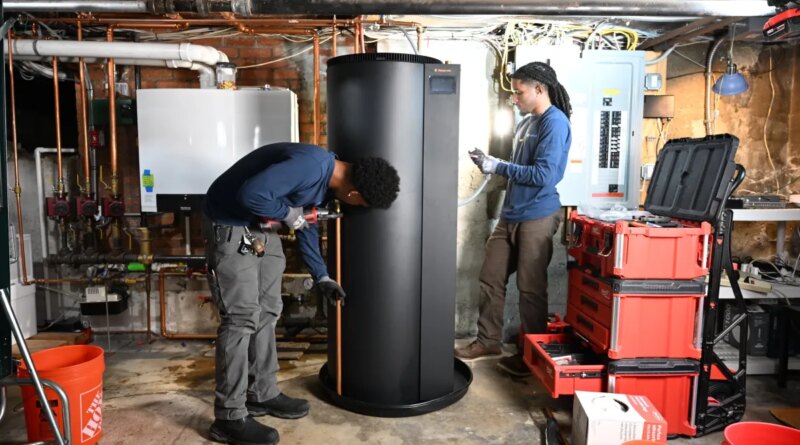 Two plumbers install a new water heater.