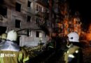 Firefighters work at the site of an apartment building hit by a Russian missile strike in Kyiv