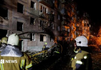 Firefighters work at the site of an apartment building hit by a Russian missile strike in Kyiv