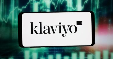 The logo of US marketing automation company Klaviyo Inc. is seen displayed on a smartphone in front of an abstract background on a computer screen.
