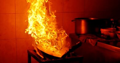 A fire rages in a kitchen.