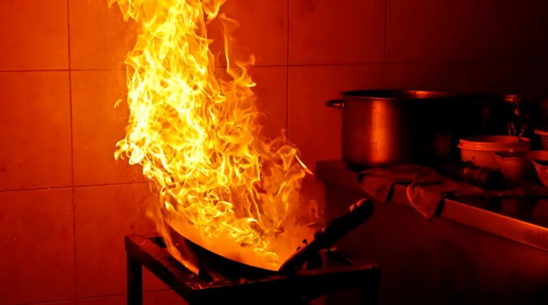 A fire rages in a kitchen.