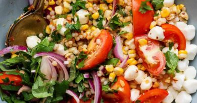 corn tomato salad with mozzarella pearls chili crunch dressing and fresh cilantro in a bowl