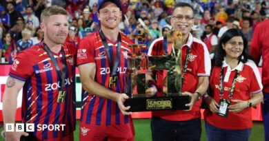 Manchester Super Giants captain Jos Buttler and owner Sanjiv Goenka hold up the 2026 men's Hundred trophy, with opener Tim Seifert (left) and Goenka's wife Preeti (right) flanking them