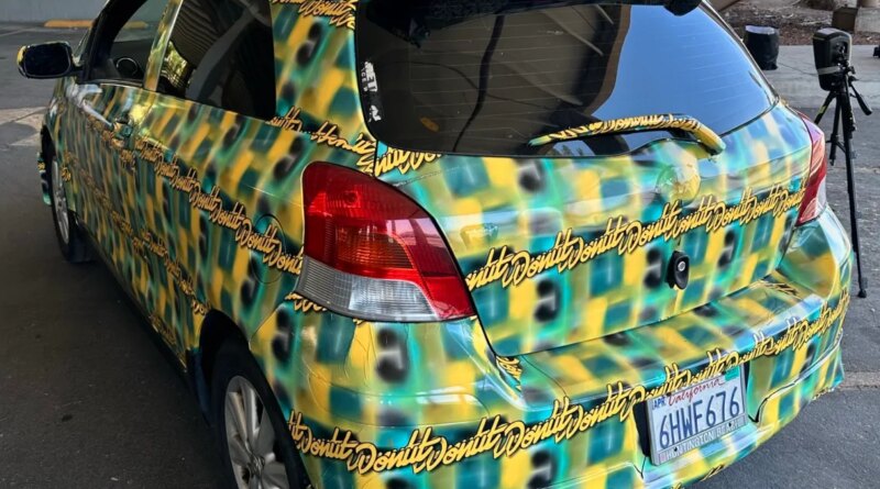 a photo of the toyota yaris covered in a pattern made by Bill Swearingen, as part of a test to see if it can defeat surveillance camera detection.