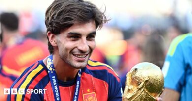 Spain forward Ferran Torres holding the World Cup trophy