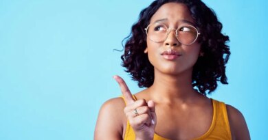 Confused woman, thinking bubble and studio mockup background. Pensive, annoyed or curious person contemplating decision. Girl with solution or idea pointing for marketing advertisement.