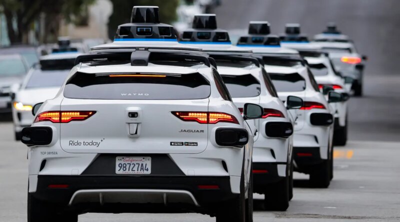 A line of Waymo robotaxis drives through North Beach on July 07, 2026 in San Francisco, California.