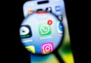 in this photo illustration, the Whatsapp app logo can be seen through a magnifying glass on the display of a smartphone.