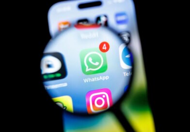 in this photo illustration, the Whatsapp app logo can be seen through a magnifying glass on the display of a smartphone.