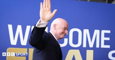 Fifa president Gianni Infantino waves while walking